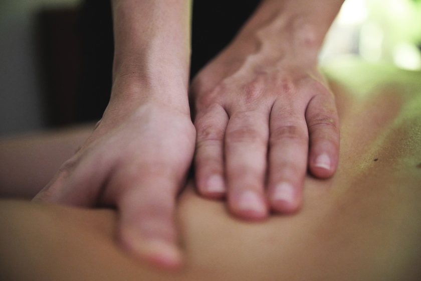 Massage therapy performed by professional therapist at Heed Spa